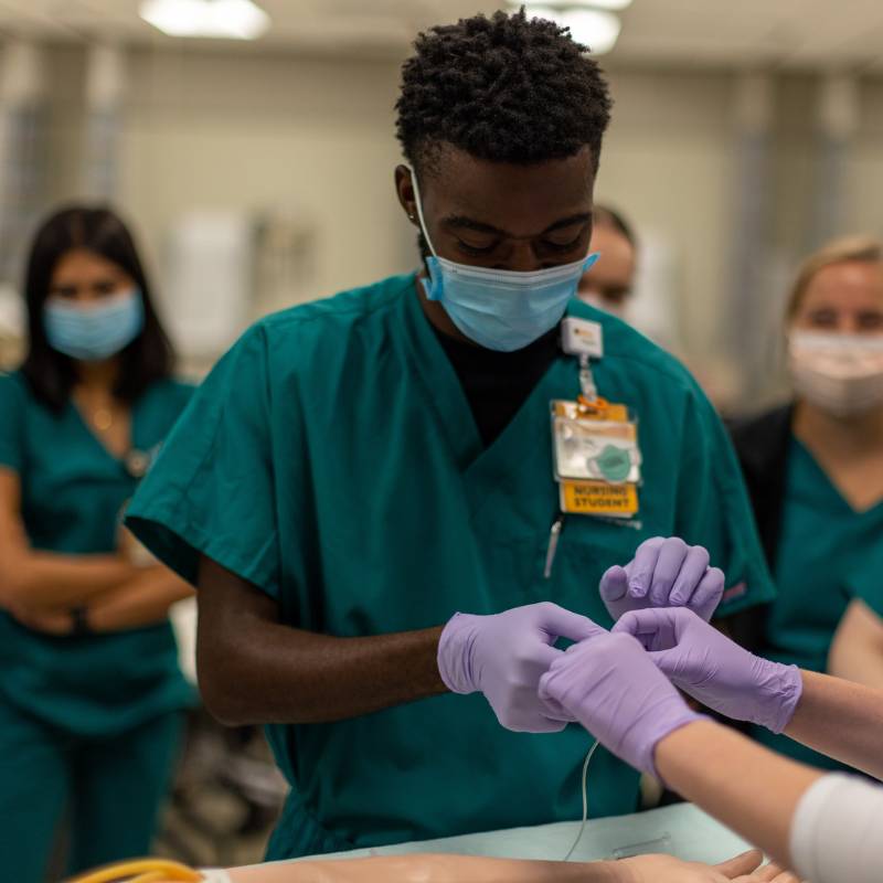 a v.c.u. nursing student practices a task in the clinical learning center