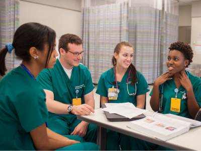 four v.c.u. nursing students talk in the clinical learning center