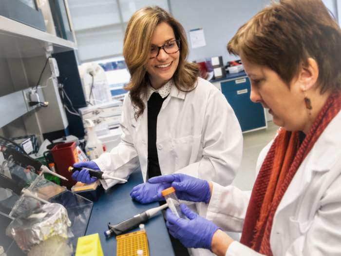 a graduate nursing student works with a faculty researcher in the biobehavioral research laboratory