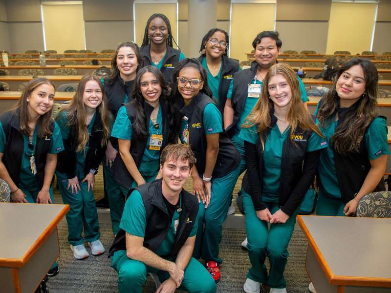 a smiling group of v.c.u. nursing students in a classroom