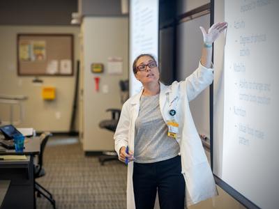 a v.c.u. nursing professor delivering a lecture in a classroom