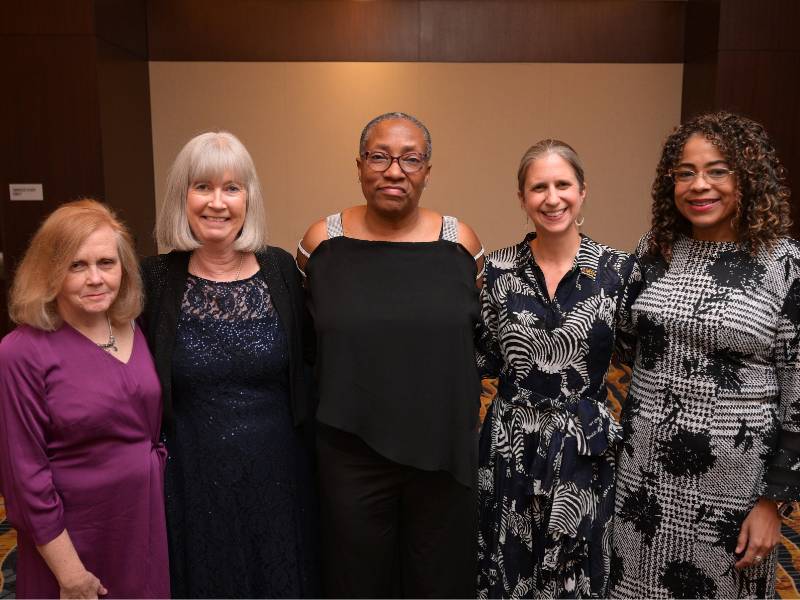 a group of u.v.a. and v.c.u. nursing faculty pose at a reception