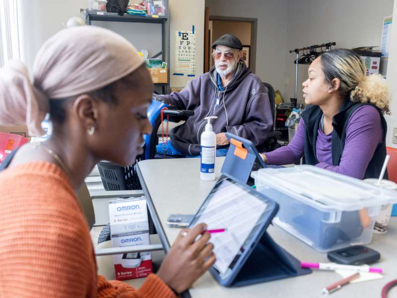 two v.c.u. nursing students meet with a participant of the mobile health and wellness program