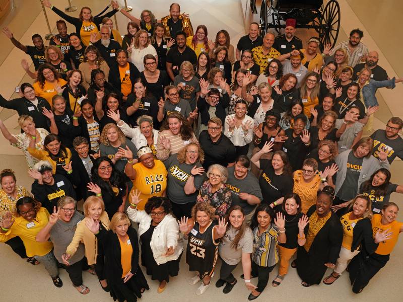 a group of v.c.u. nursing faculty and staff in black and gold wear