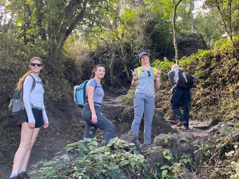 four v.c.u. nursing students dressed in hiking gear headed up a steep, rocky trail in a verdant setting