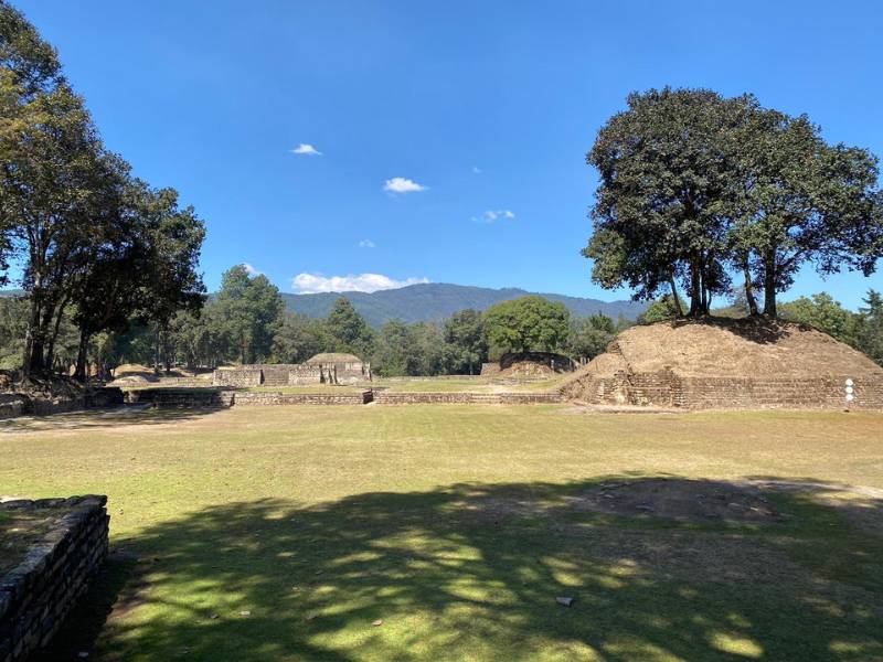 ancient mayan ruins in a verdant, mountainous setting