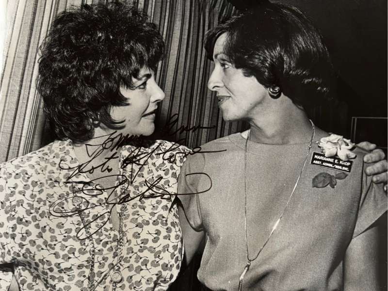 a young elizabeth taylor with her arm around marianne krop - the photo is signed by elizabeth taylor