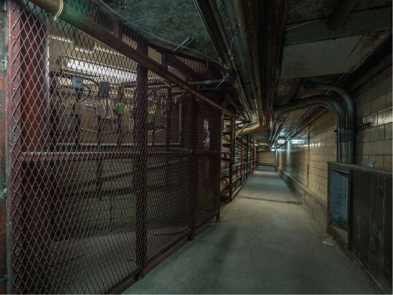 a dimly lit pedestrian tunnel under the health sciences campus