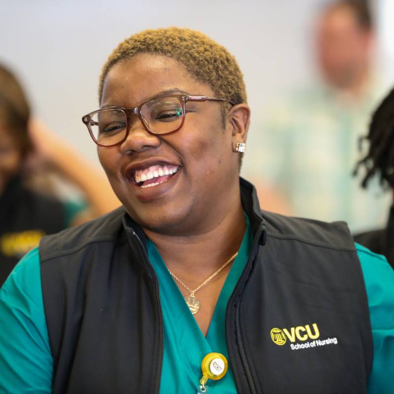 a v.c.u. nursing student smiles at the vesting ceremony