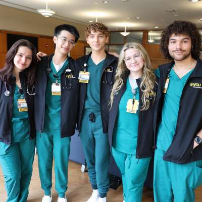 a group of v.c.u. nursing students smile in a group following the vesting ceremony