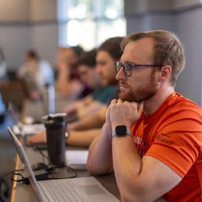 students take notes on laptops in a v.c.u. lecture classroom