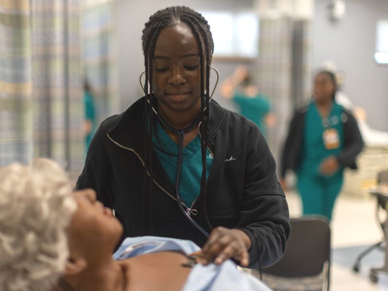 A nursing student participates in a simulation