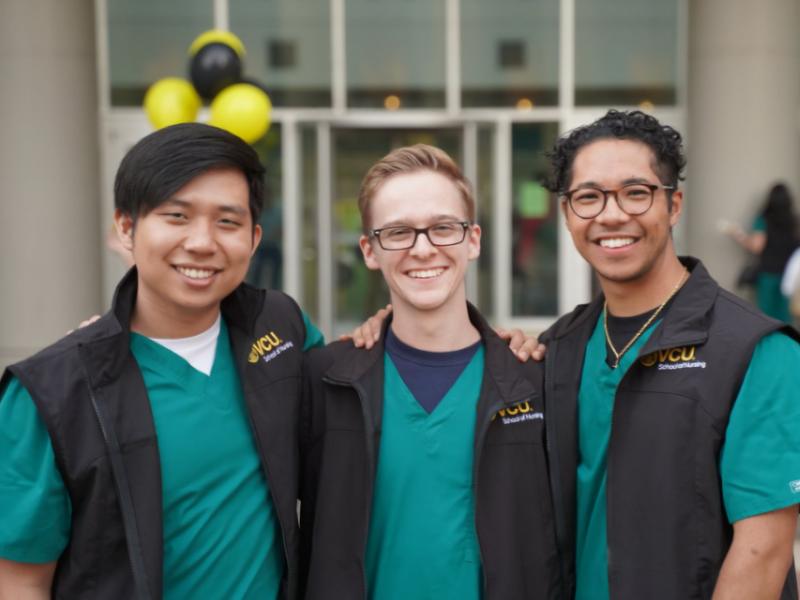 three v.c.u. nursing students pose together and smile for the camera